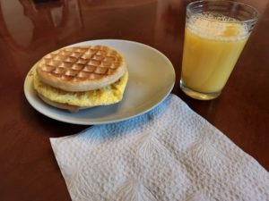 Ludum Dare 50 breakfast: peanut butter, cinnamon, egg on waffles with a small glass of orange juice
